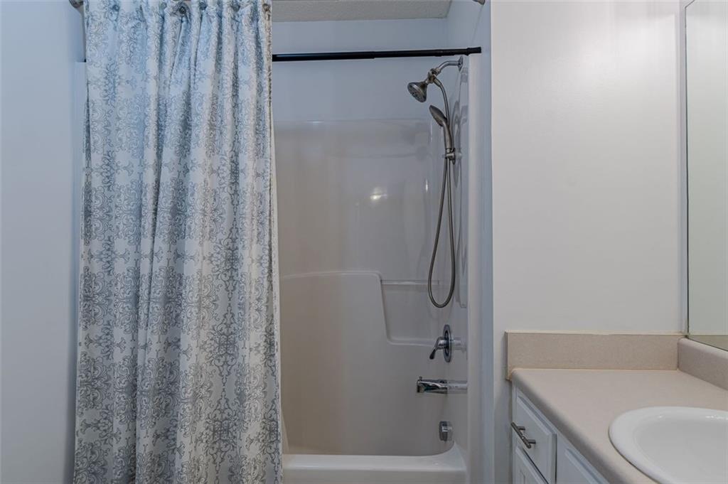 7640 Rutgers Circle Fairburn, GA 30213 - Photo 41 of 49 a bathroom with a shower and a sink