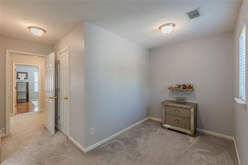 7640 Rutgers Circle Fairburn, GA 30213 - Photo 46 of 49 an empty room with a bench and mirror