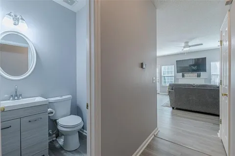 a en suite bathroom with a sink mirror and shower