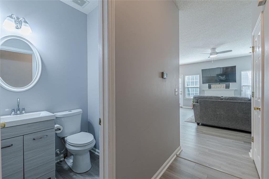7640 Rutgers Circle Fairburn, GA 30213 - Photo 8 of 49 a en suite bathroom with a toilet sink and mirror