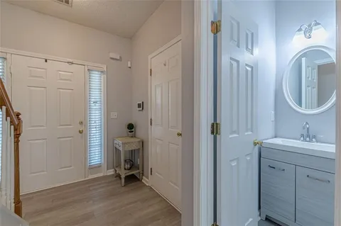 a bathroom with a toilet a sink and mirror