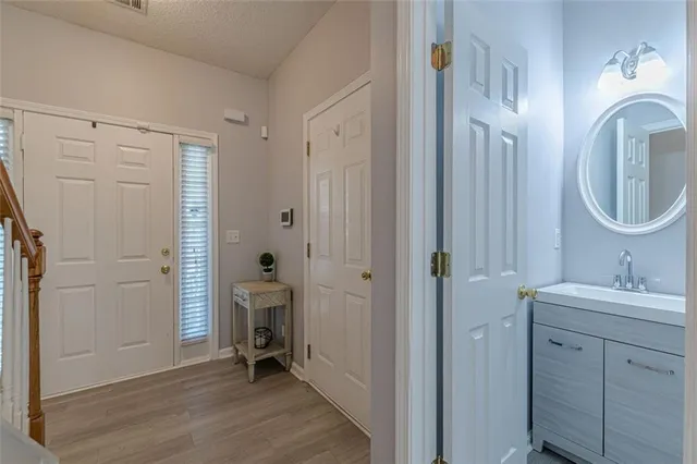 a bathroom with a toilet a sink and mirror