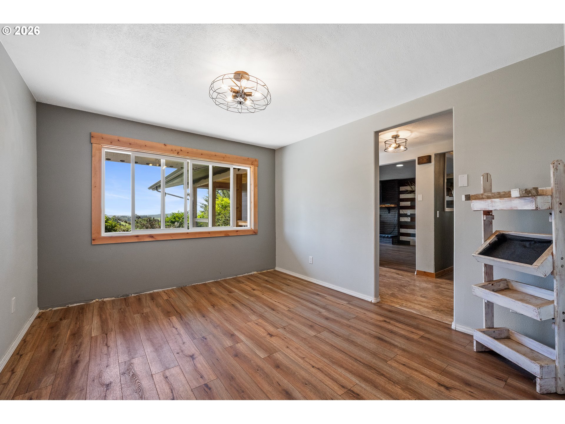 850 Hodgdon Road Tillamook, OR 97141 - Photo 11 of 43 a view of an empty room with a window and wooden floor