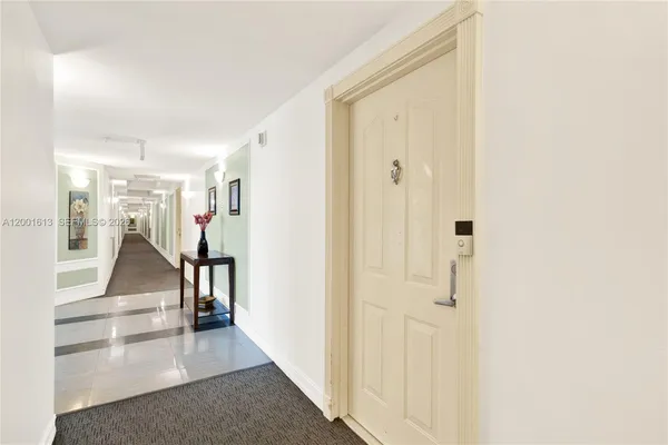 a view of a hallway with wooden floor and entryway