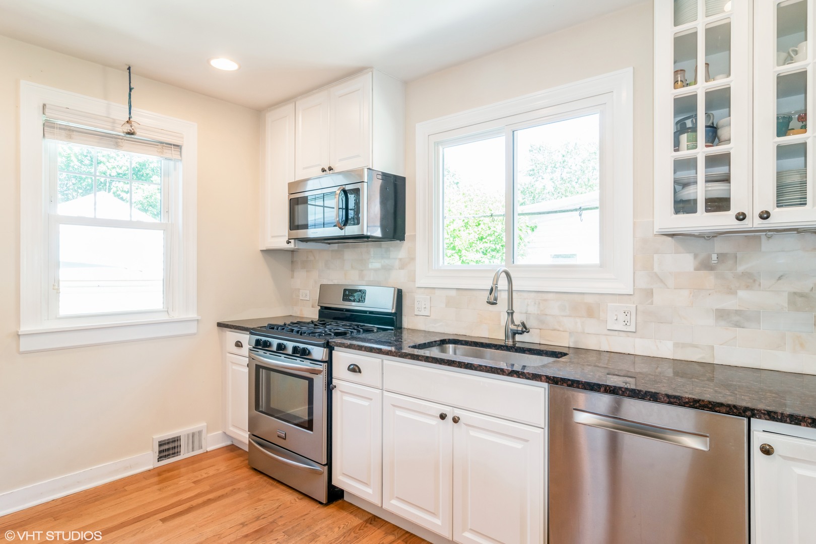 528 Selborne Road Riverside, IL 60546 - Photo 6 of 21 a kitchen with granite countertop a stove a sink and a window