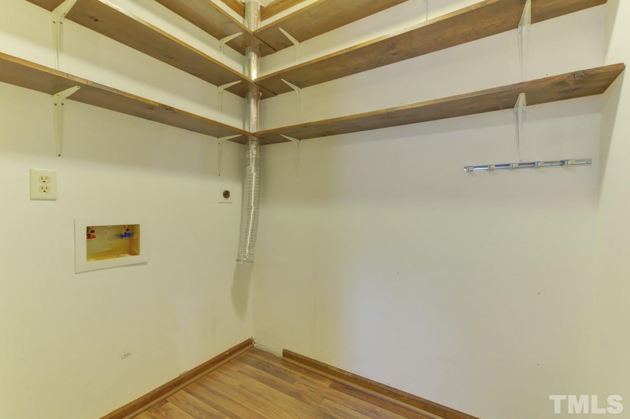 5505 Hamstead Crossing Raleigh, NC 27612 - Photo 13 of 25 a view of a room with wooden floor and white walls