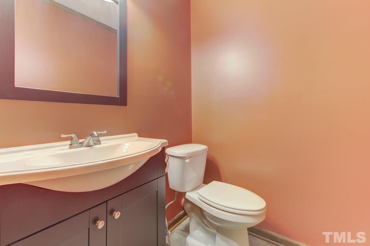 5505 Hamstead Crossing Raleigh, NC 27612 - Photo 14 of 25 a bathroom with a sink a toilet and mirror