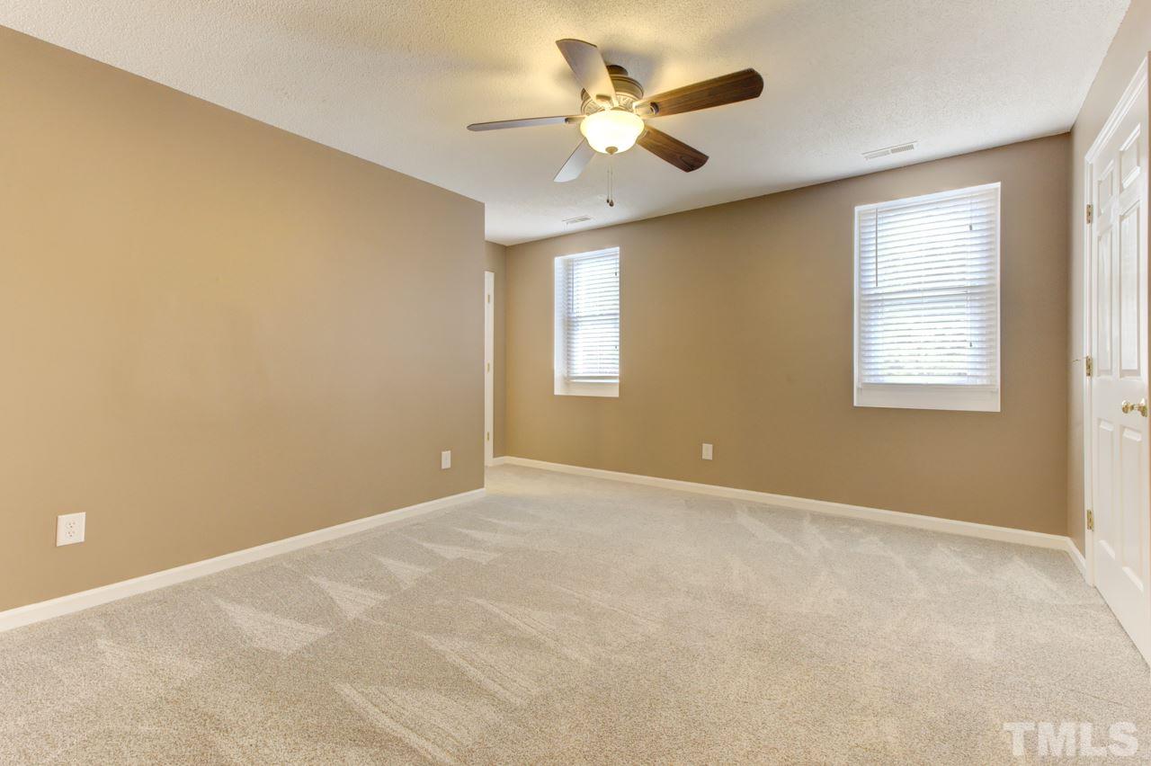 5505 Hamstead Crossing Raleigh, NC 27612 - Photo 15 of 25 an empty room with windows and ceiling fan