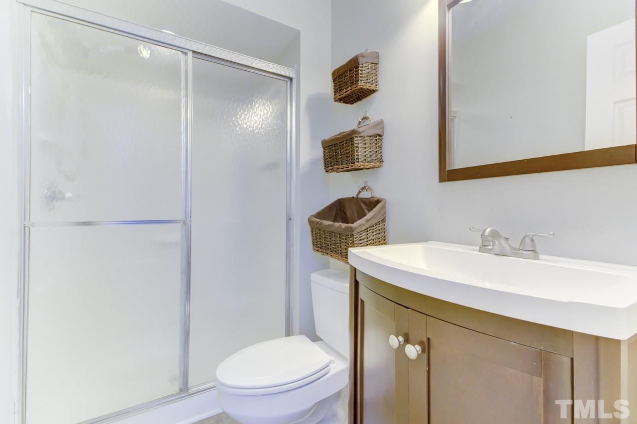 5505 Hamstead Crossing Raleigh, NC 27612 - Photo 16 of 25 a bathroom with a sink toilet vanity and shower