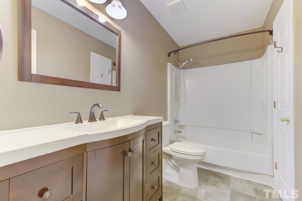 5505 Hamstead Crossing Raleigh, NC 27612 - Photo 19 of 25 a bathroom with a sink a toilet and shower