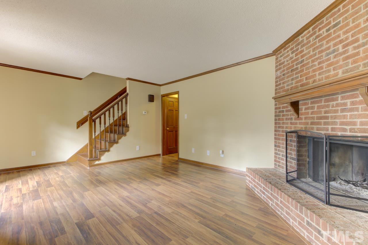 5505 Hamstead Crossing Raleigh, NC 27612 - Photo 5 of 25 a view of an empty room with wooden floor