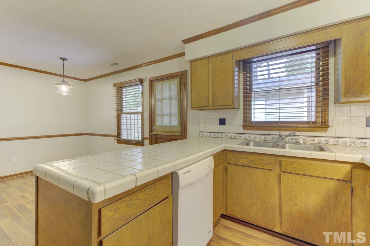 5505 Hamstead Crossing Raleigh, NC 27612 - Photo 10 of 25 a kitchen with a sink and cabinets