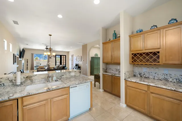 a bathroom with a granite countertop double vanity sink and a mirror