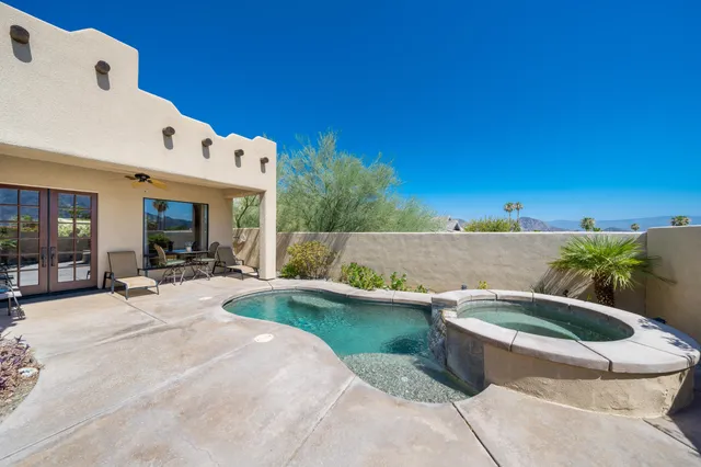 a view of a patio with chairs and plants