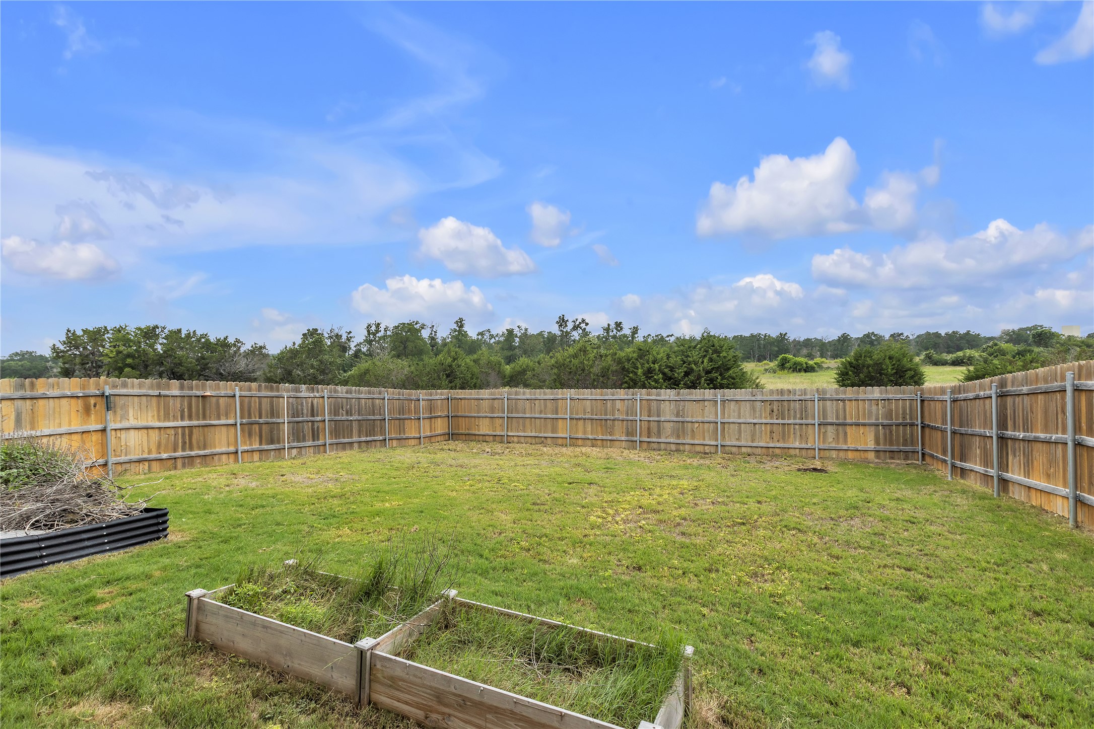 1212 Tipton Street Georgetown, TX 78633 - Photo 18 of 20 A spacious, enclosed yard provides privacy and a verdant backdrop for outdoor activities.