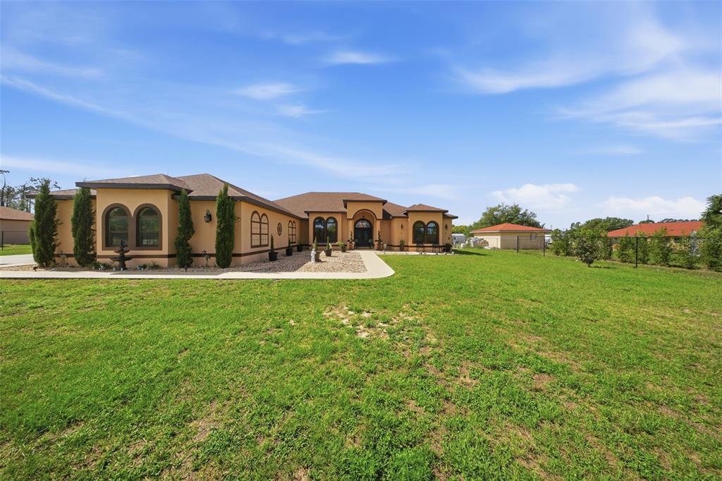 13429 Montevista Road Clermont, FL 34711 - Photo 72 of 89 a view of a house with a big yard