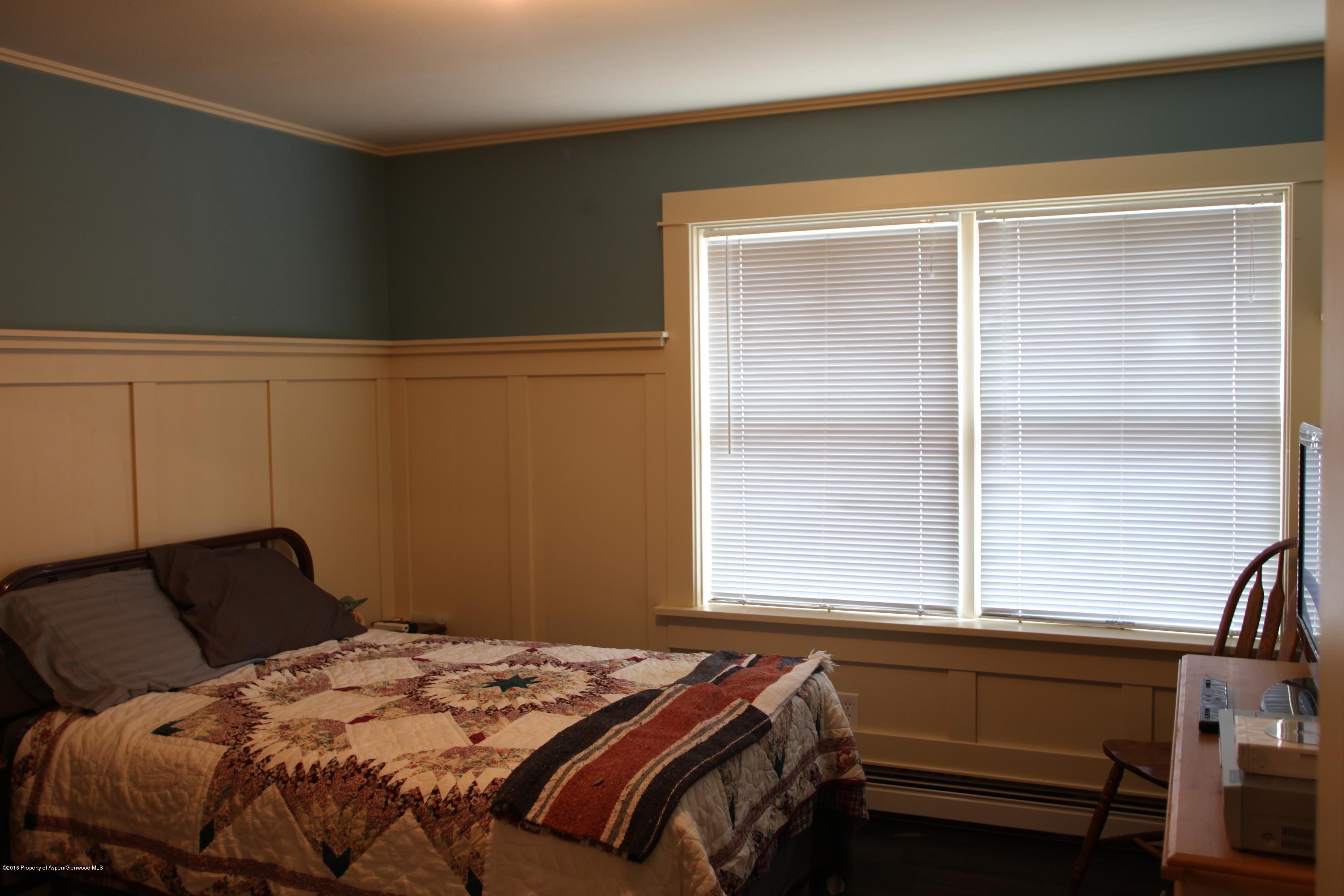 450 Redstone Boulevard Redstone, CO 81623 - Photo 13 of 16 a bedroom with a bed and a window