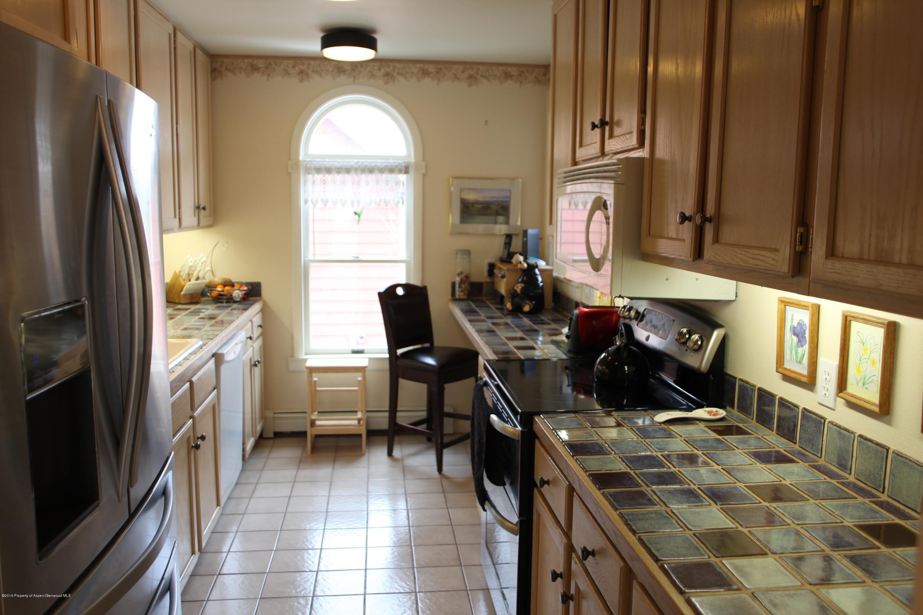 450 Redstone Boulevard Redstone, CO 81623 - Photo 5 of 16 a kitchen with cabinets and chairs
