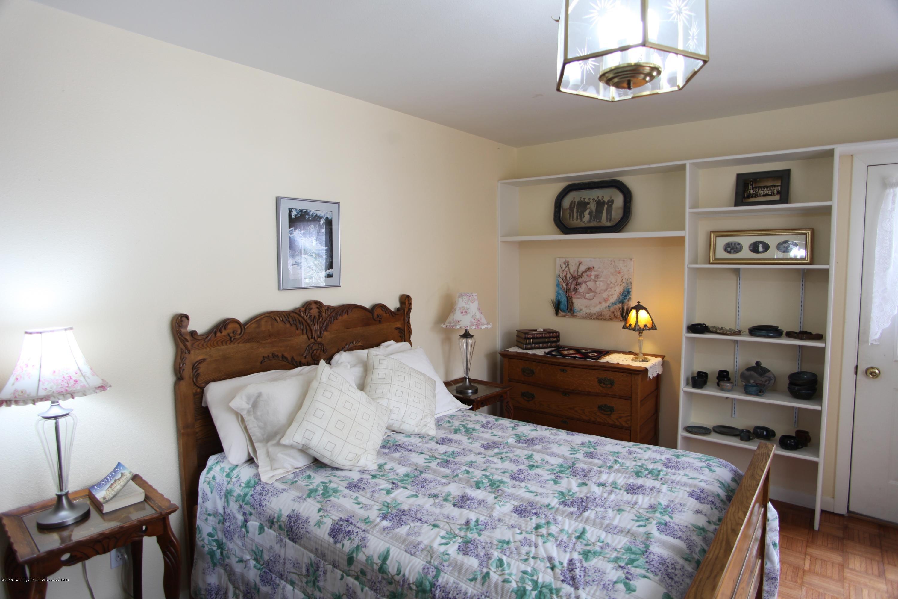 450 Redstone Boulevard Redstone, CO 81623 - Photo 7 of 16 a bedroom with a bed and wooden floor