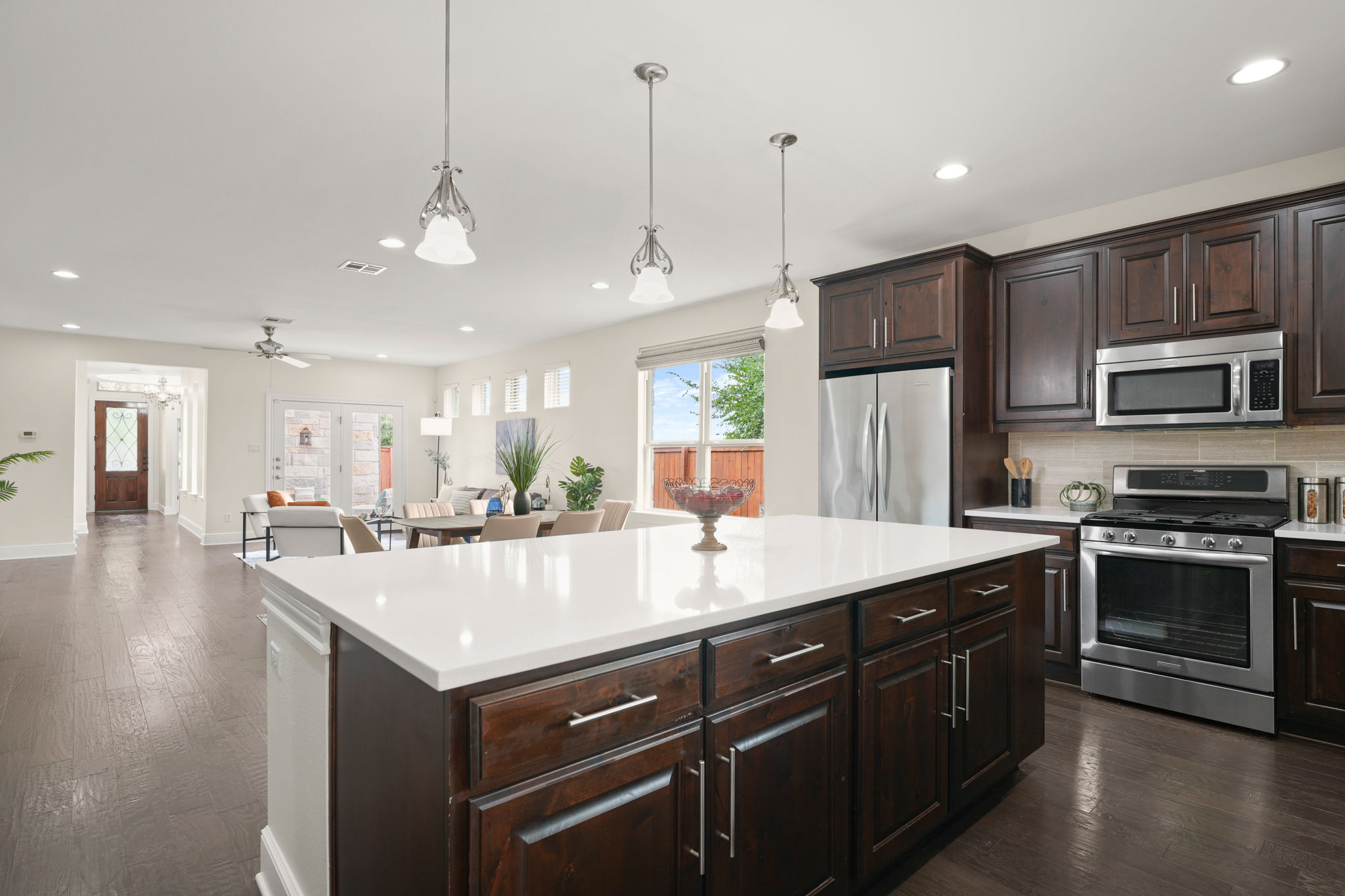 440 Cherokee Rose Circle Georgetown, TX 78626 - Photo 5 of 39 An inviting open-concept kitchen features a spacious island and seamlessly connects to living and dining areas.