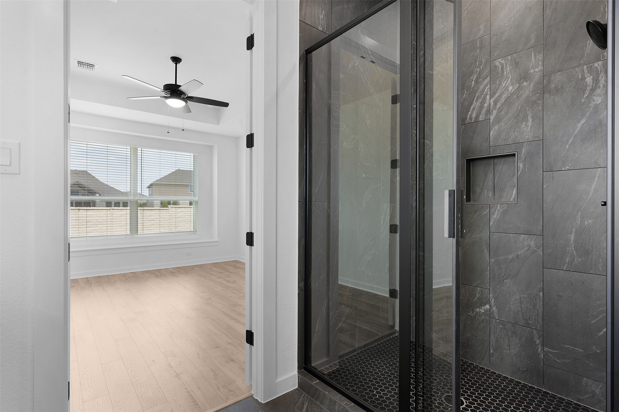 19504 Domino Champ Road Pflugerville, TX 78660 - Photo 16 of 24 Full bath with a stall shower, light wood finished floors, and ceiling fan