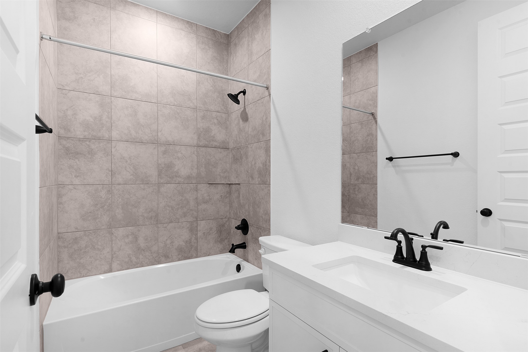 19504 Domino Champ Road Pflugerville, TX 78660 - Photo 5 of 24 Bathroom with vanity and washtub / shower combination