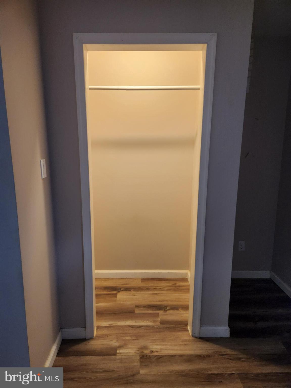 9349 Valley Road, Unit 107 Berkeley Springs, WV 25411 - Photo 5 of 8 a view of a small room with wooden floor and a window