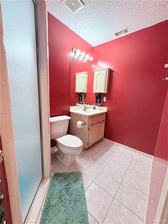 2218 Lawndale Road Mission, TX 78572 - Photo 16 of 24 Bathroom with tile patterned floors, visible vents, a textured ceiling, and a stall shower