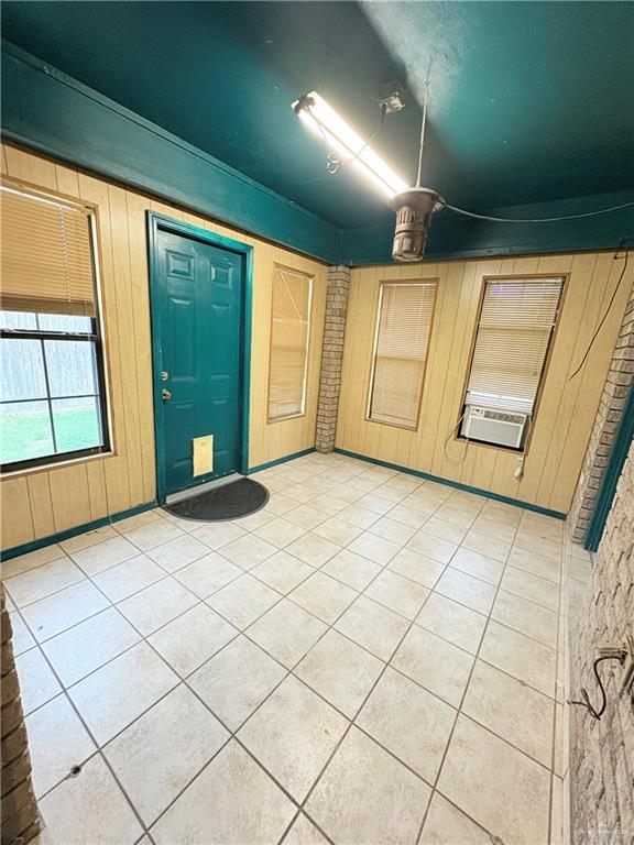 2218 Lawndale Road Mission, TX 78572 - Photo 17 of 24 Entryway featuring cooling unit, wooden walls, and light tile patterned floors