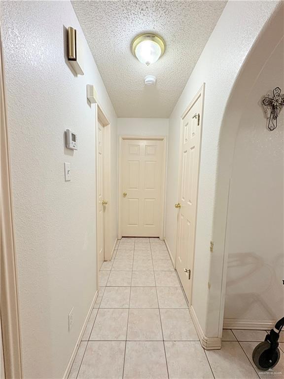 2218 Lawndale Road Mission, TX 78572 - Photo 22 of 24 Hall featuring baseboards, a textured ceiling, and light tile patterned floors