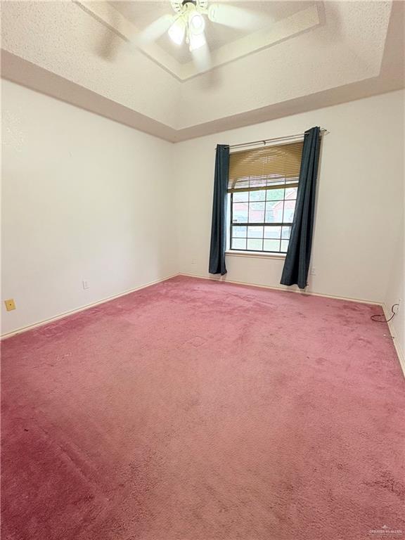 2218 Lawndale Road Mission, TX 78572 - Photo 23 of 24 Carpeted spare room featuring a raised ceiling, baseboards, and ceiling fan