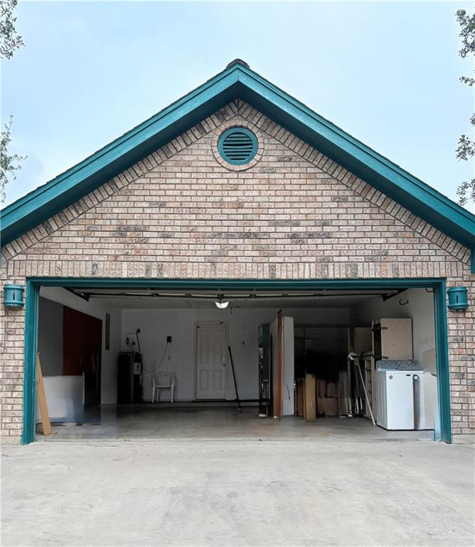 2218 Lawndale Road Mission, TX 78572 - Photo 24 of 24 Garage with driveway, washer and clothes dryer, and electric water heater