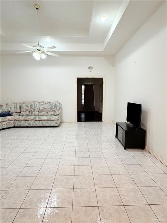 2218 Lawndale Road Mission, TX 78572 - Photo 3 of 24 Unfurnished living room with light tile patterned flooring, a raised ceiling, ceiling fan, and recessed lighting