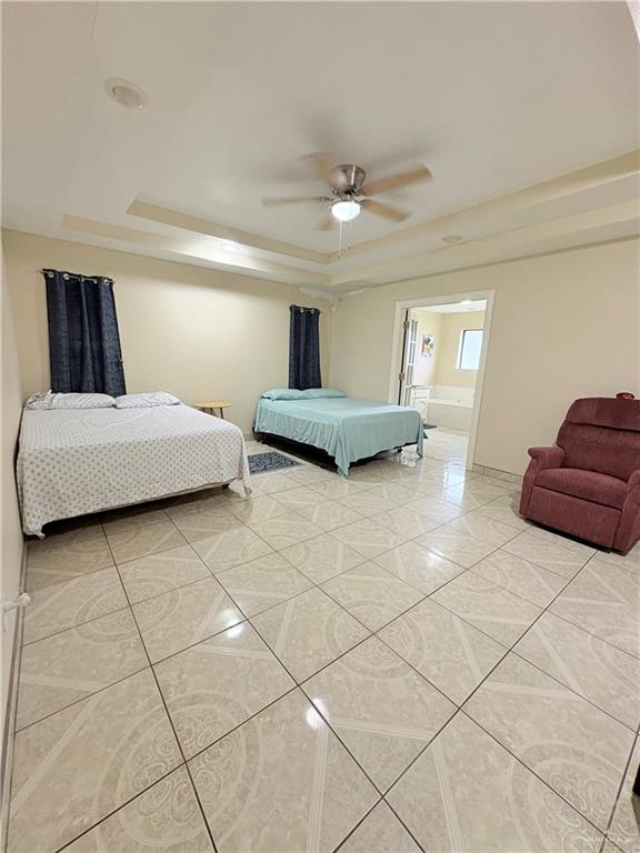 2218 Lawndale Road Mission, TX 78572 - Photo 9 of 24 Bedroom featuring light tile patterned flooring, a raised ceiling, baseboards, and ceiling fan