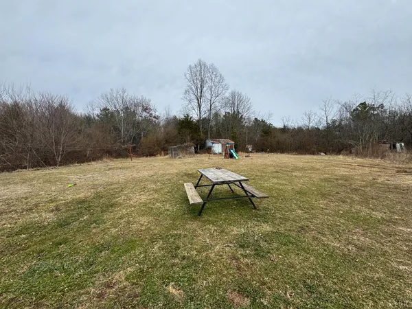 a park bench sitting in the middle of a yard