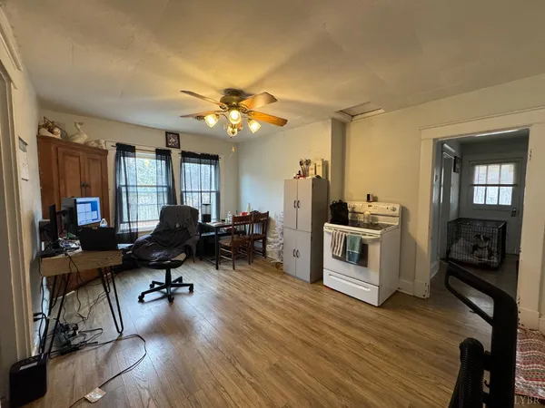 a view of a livingroom with furniture and a flat screen tv