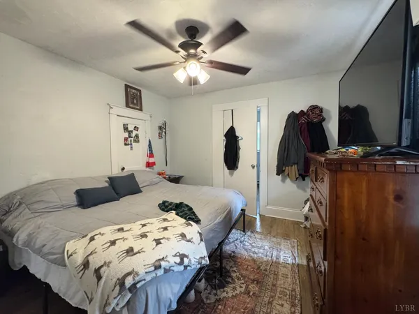a bedroom with bed and a chandelier