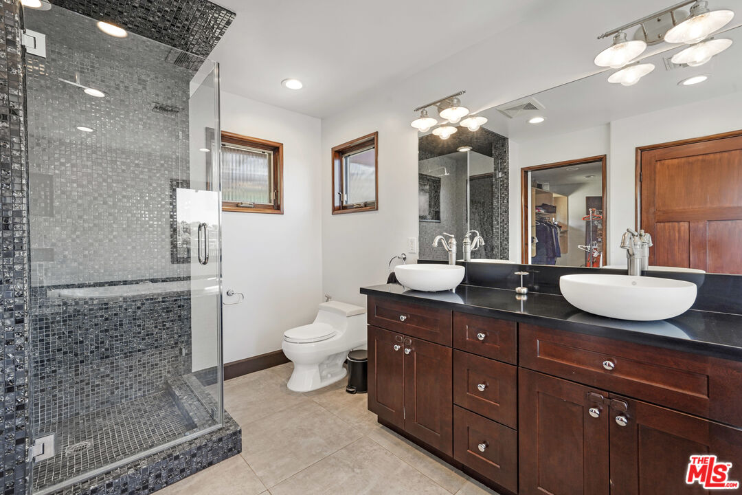 458 Rustic Drive Los Angeles, CA 90065 - Photo 14 of 41 a bathroom with a granite countertop sink a toilet and a mirror