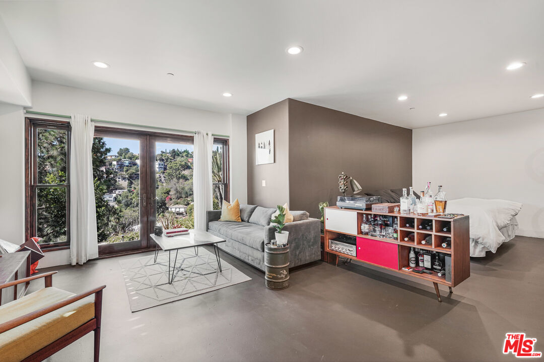 458 Rustic Drive Los Angeles, CA 90065 - Photo 35 of 41 a living room with furniture gym equipment and a large window