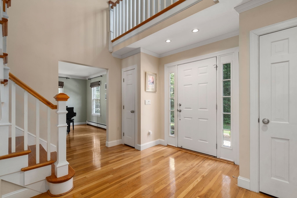 24 Russett Hill Road Sherborn, MA 01770 - Photo 3 of 39 a view of a livingroom with wooden floor and stairs