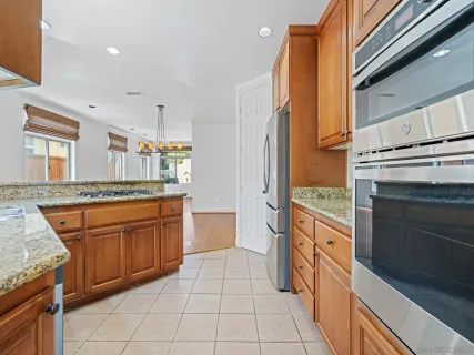 a kitchen with stainless steel appliances granite countertop a sink and cabinets