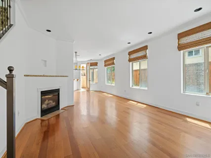 a view of an empty room with window and fire place