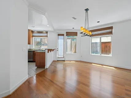 a view of a kitchen with a sink dishwasher and wooden floor
