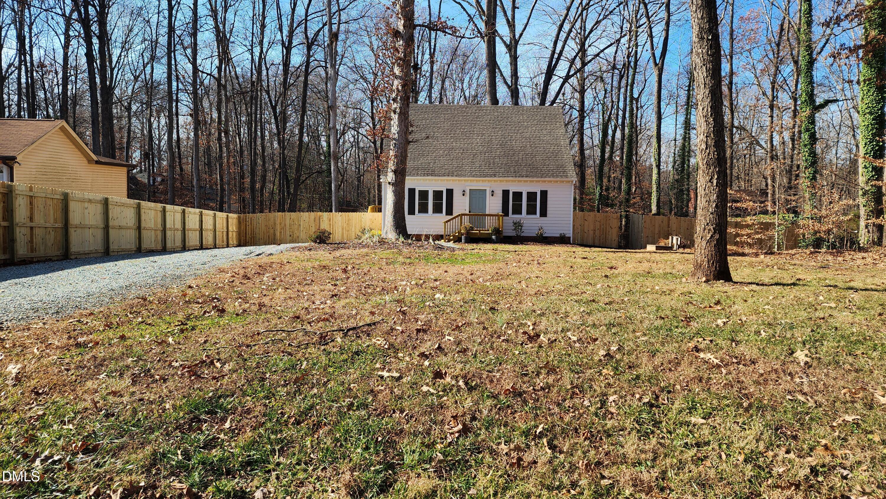 a view of a house with a yard covered in snow