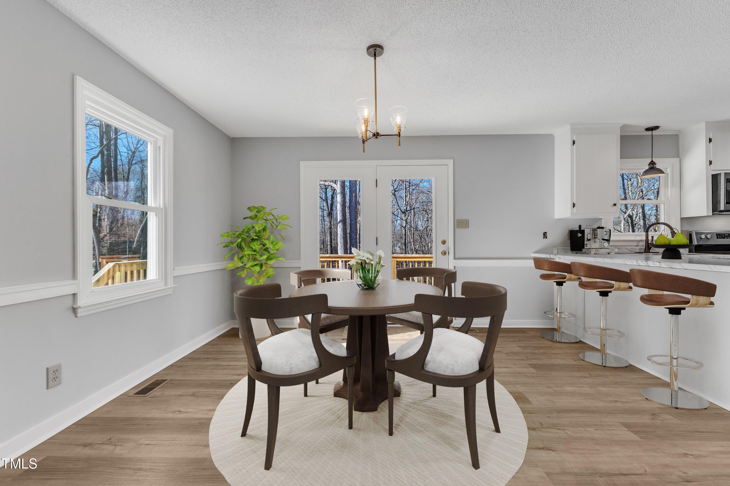 612 Miller Road Hillsborough, NC 27278 - Photo 8 of 35 a view of a dining room with furniture window and wooden floor