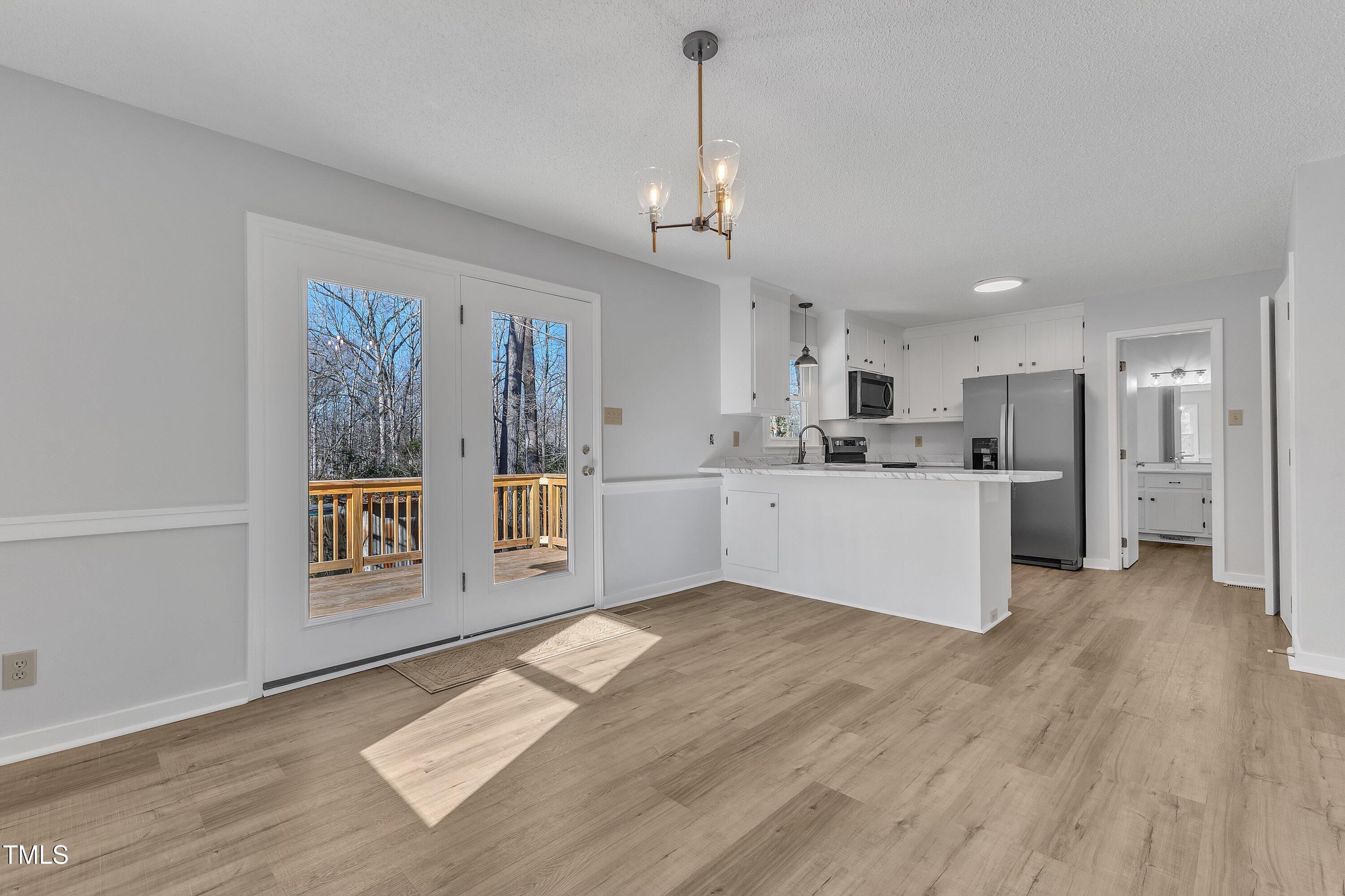 612 Miller Road Hillsborough, NC 27278 - Photo 9 of 35 a view of kitchen with wooden floor and window