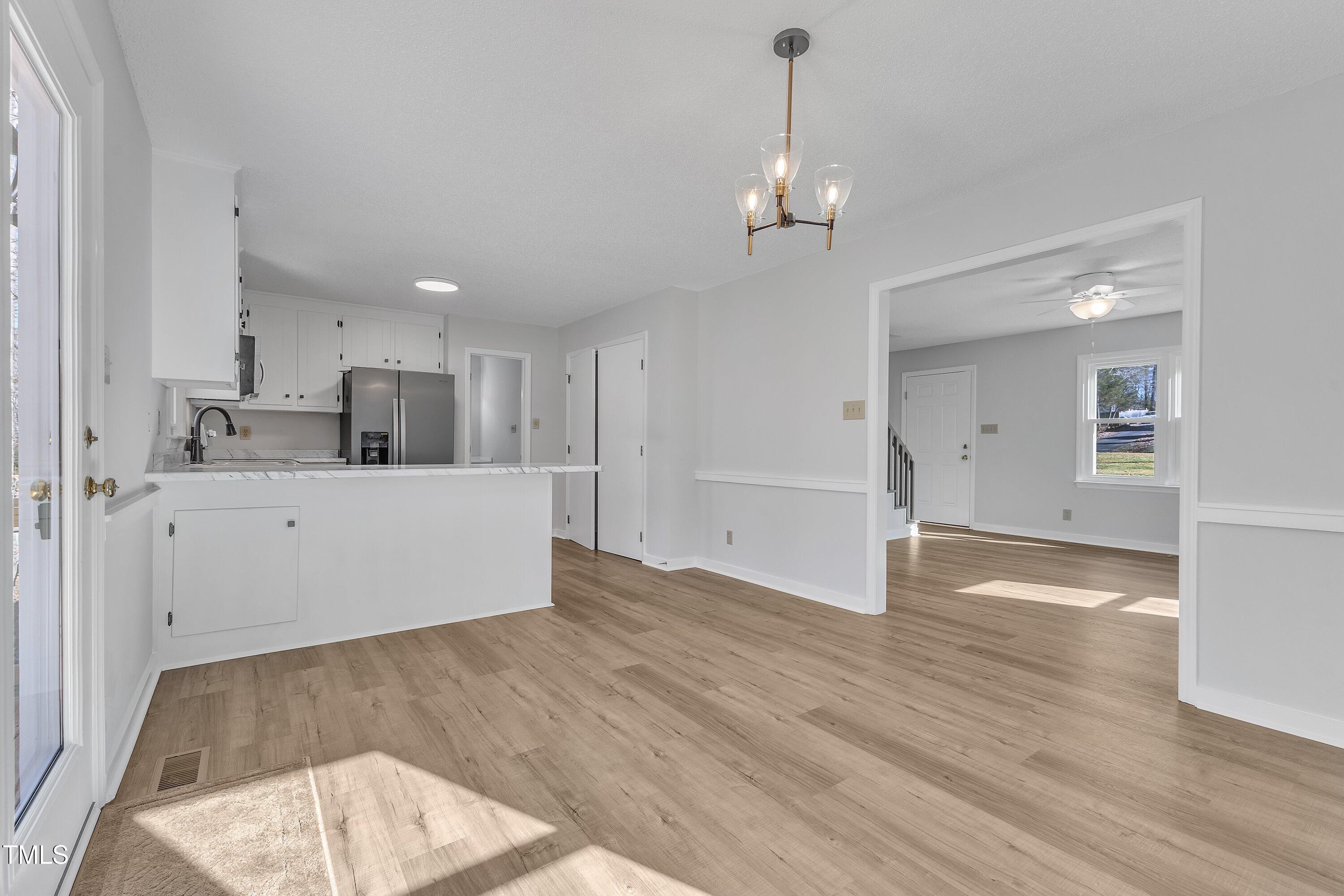 612 Miller Road Hillsborough, NC 27278 - Photo 10 of 35 a view of a kitchen with a sink and dishwasher with wooden floor