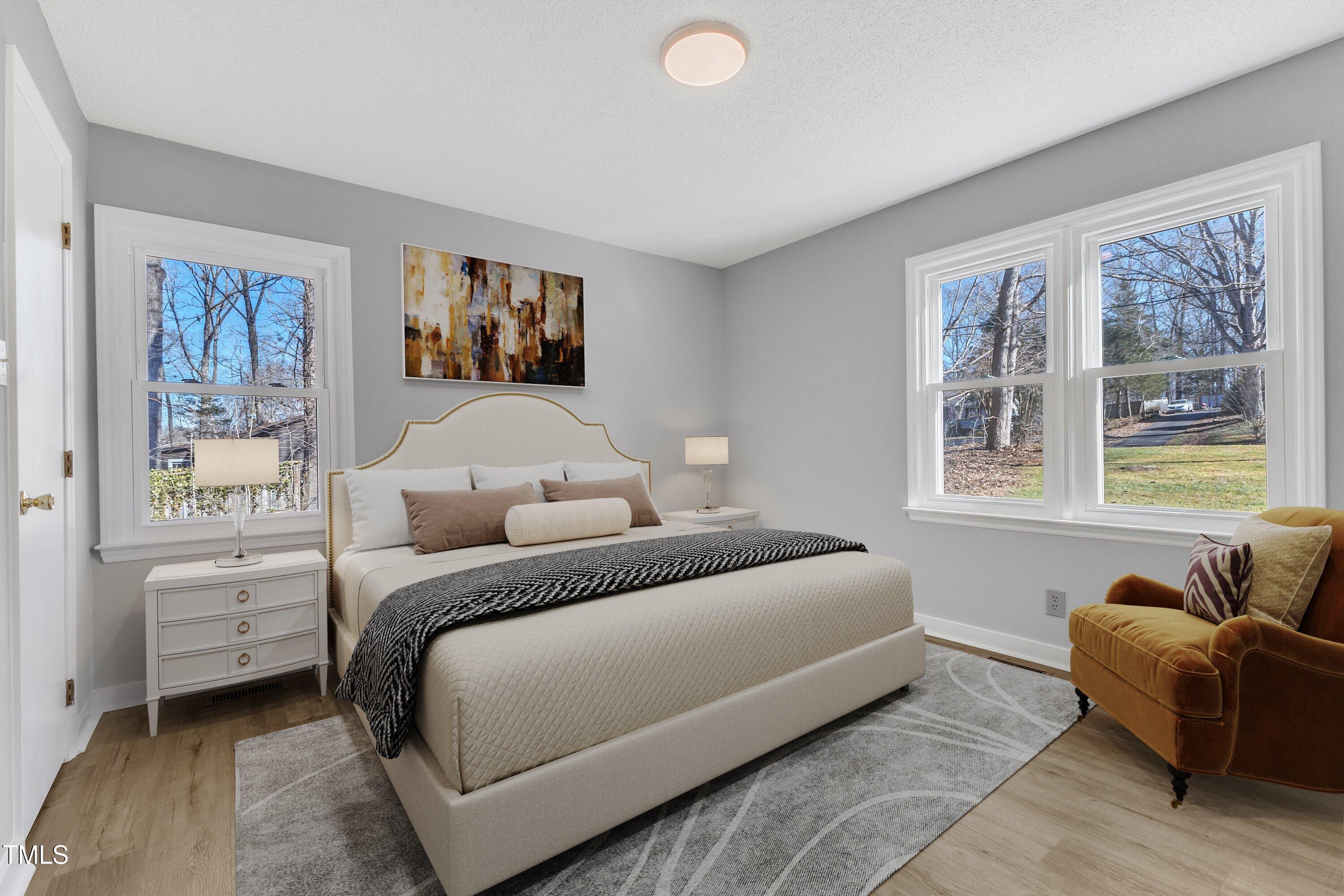 612 Miller Road Hillsborough, NC 27278 - Photo 16 of 35 a bedroom with a large bed and a couch