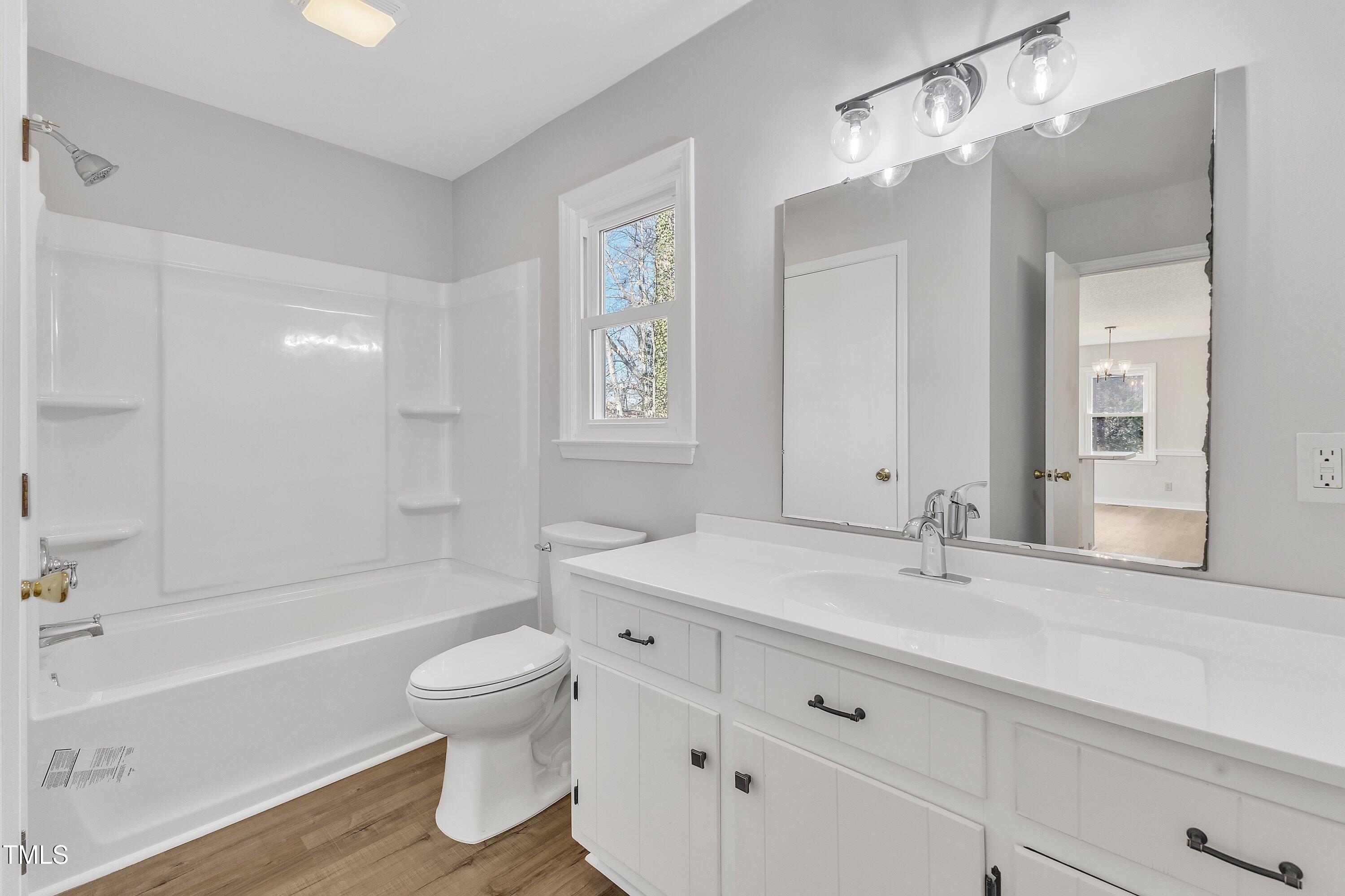 612 Miller Road Hillsborough, NC 27278 - Photo 17 of 35 a bathroom with a sink a toilet and a large mirror