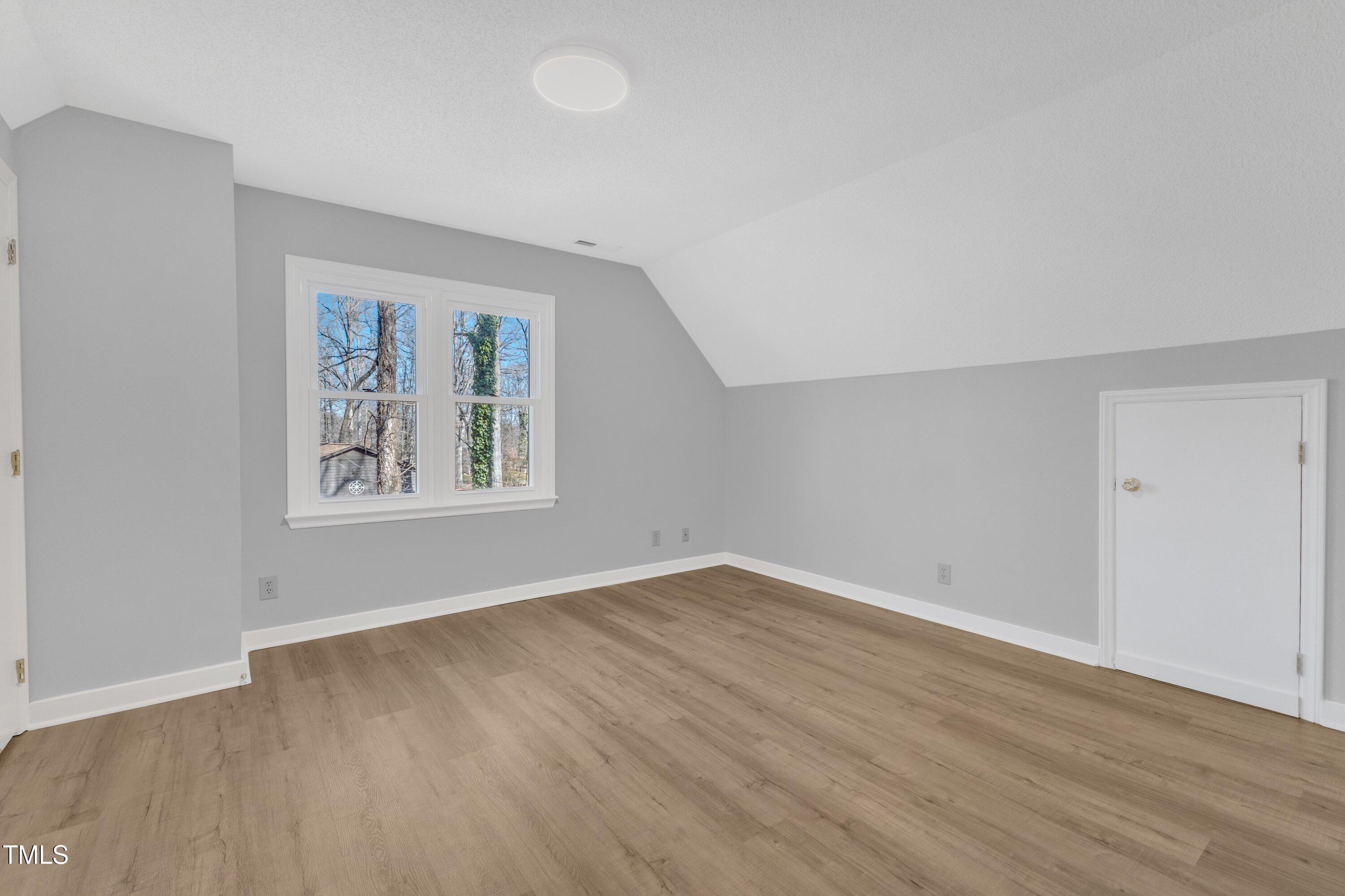612 Miller Road Hillsborough, NC 27278 - Photo 19 of 35 an empty room with wooden floor and windows